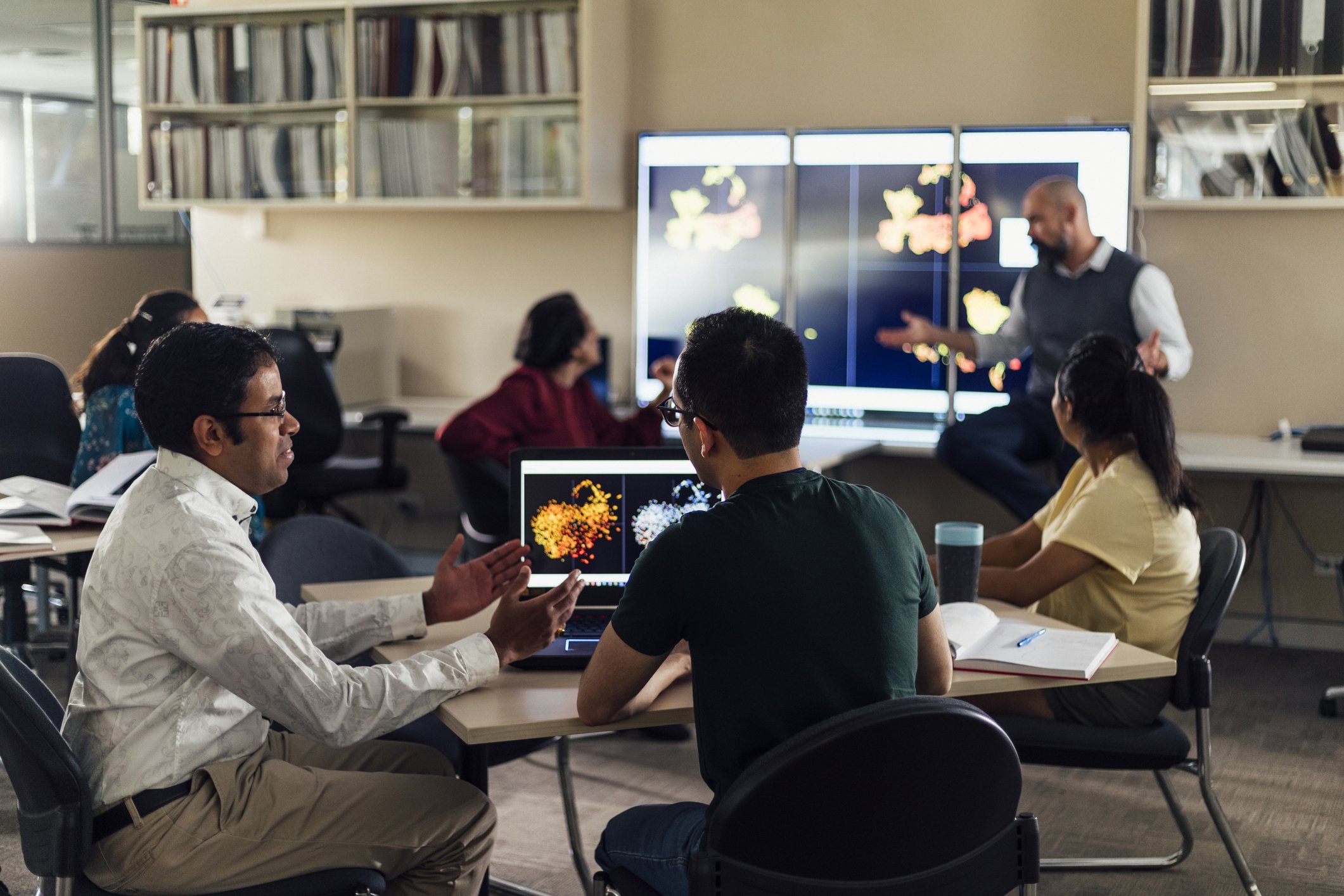 3 older students at a classroom table