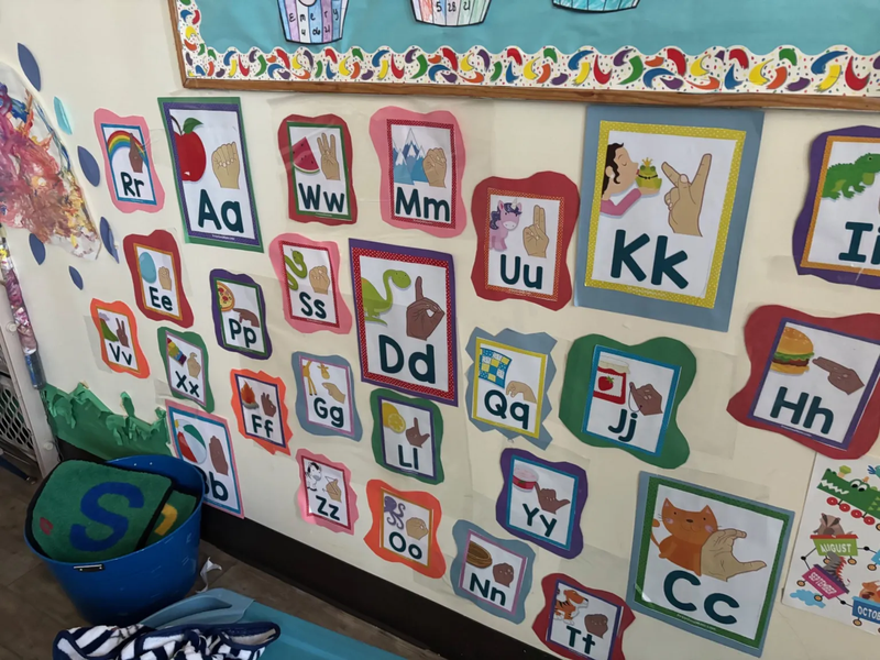 Child care classroom with children, including a child with a disability, learning together under teacher supervision—illustrating inclusive early education efforts.