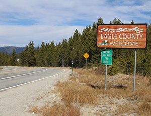 A sign that says, "Eagle County / Welcome." The sign is at the top of Tennessee Pass on the Eagle Couinty / Lake County border in Colorado.