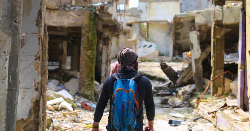 Man with Phone in Ruins