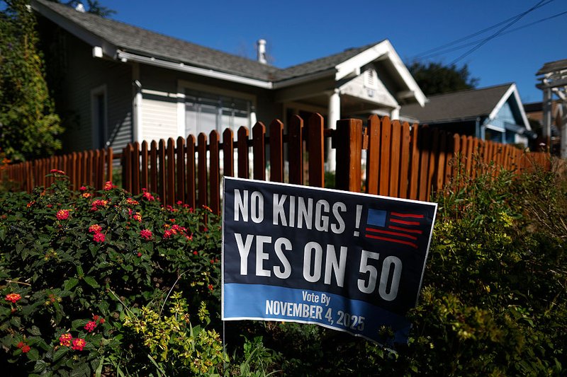 A “Yes on 50” sign is posted in front of a home in San Anselmo, California.