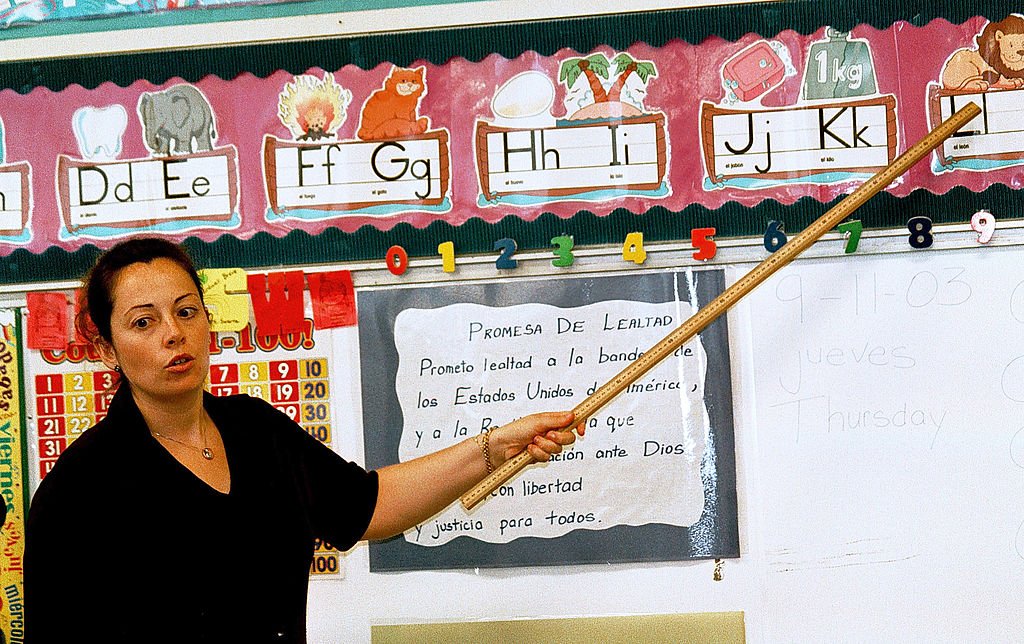 A Spanish speaking first grade teacher, instructs a class on the Spanish pronunciations of the alphabet at Birdwell Elementary School