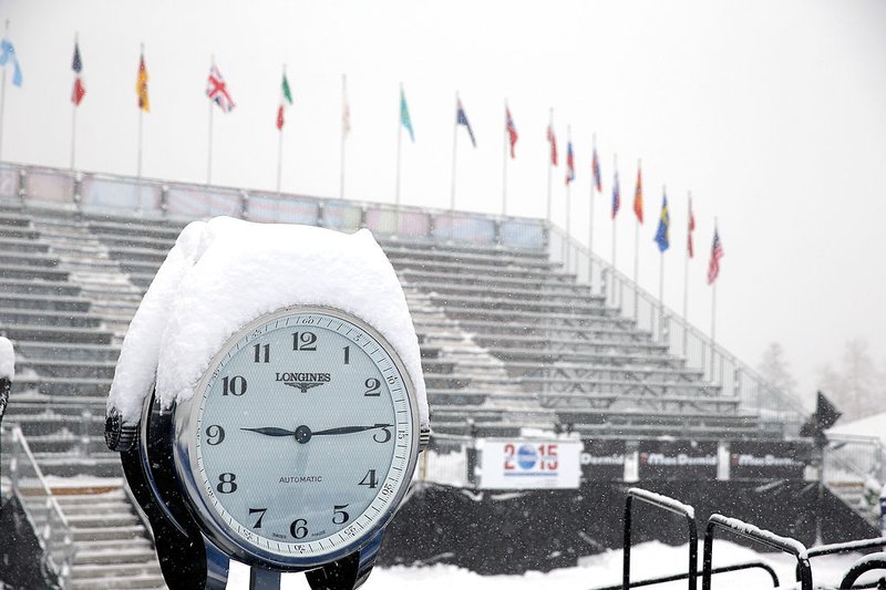 Snow falls over clock.