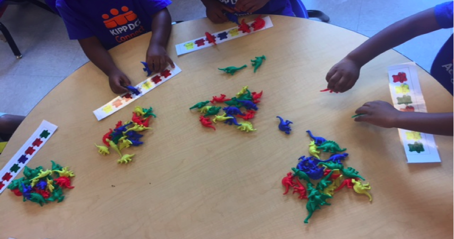 KIPP DC Connect Academy Pre-K students matching colors and identifying patterns at a math center.