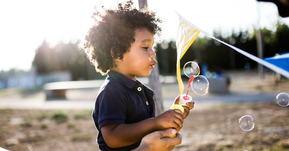 boy blowing bubbles