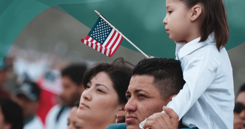 People in a crowd waving American flags