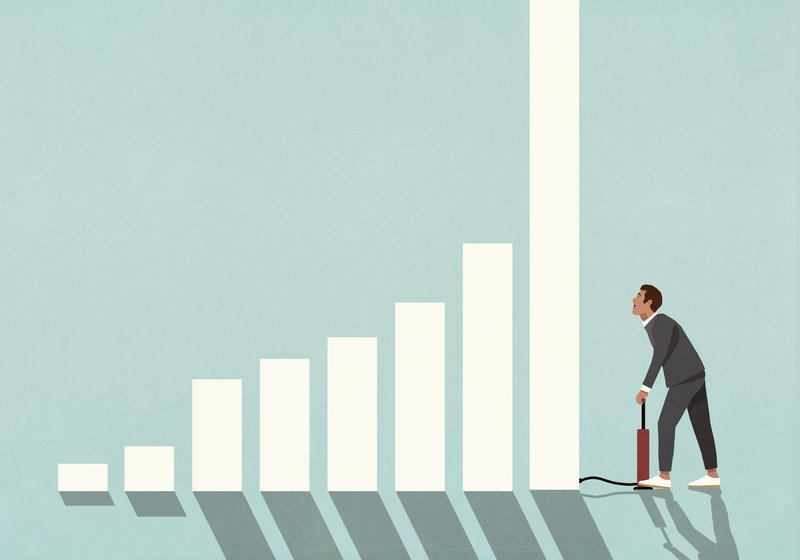 A man pumps up a bar in a bar graph with an air pump.