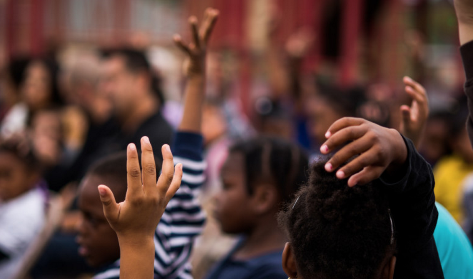 kids raising hands
