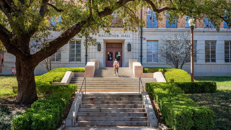 A student walks to the Waggener Hall at the University of Texas at Austin.