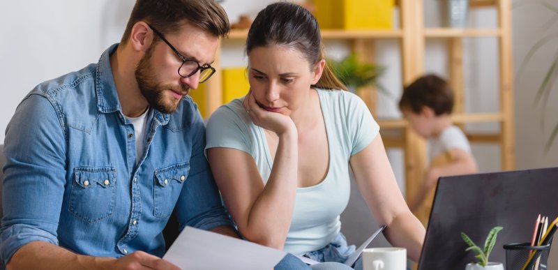 Family with a child having financial problems, doing home budgeting, calculating expenses.