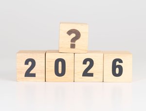 Light-colored wood blocks with the numbers 2026 and a question mark