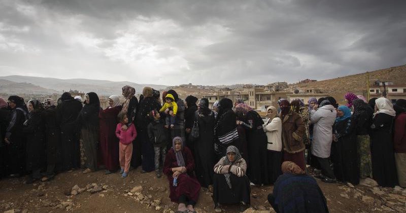 A long line of women wait to register with UNHCR in Arsal, Lebanon
