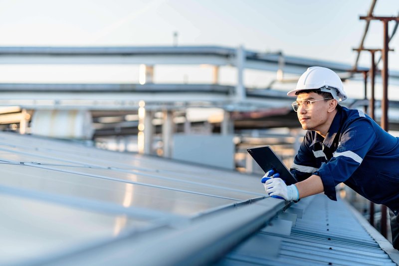 A male worker leans on an energy grid.