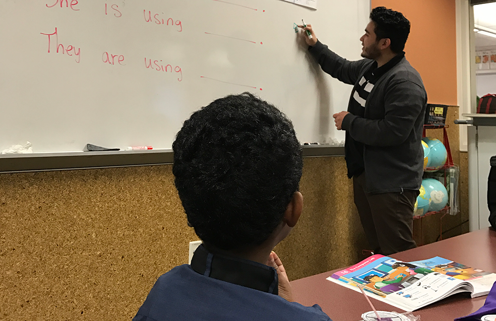dual language learner teacher at a whiteboard