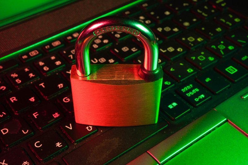 A closed padlock on a laptop keyboard