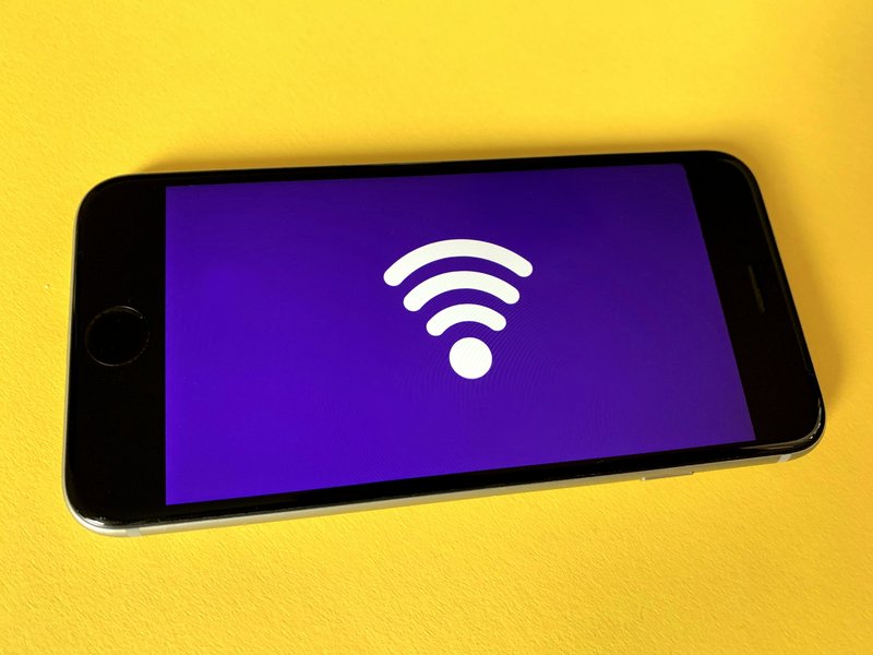 WiFi symbol displayed on a phone against a yellow background