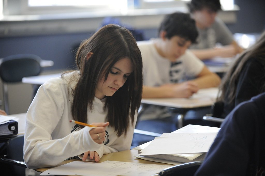 college student taking test classroom