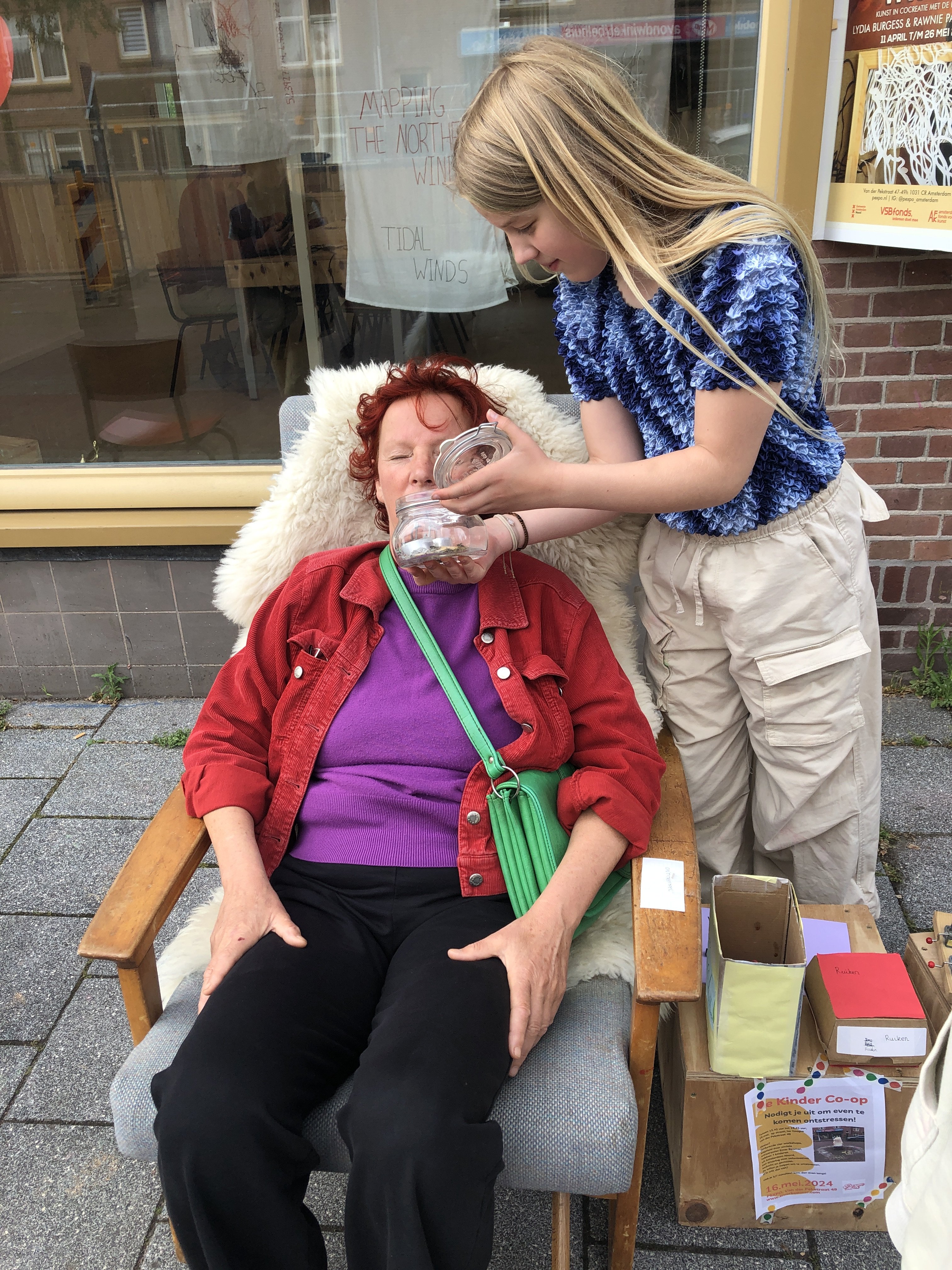 A woman smells a jar of rosemary prepared by a child to help her relax