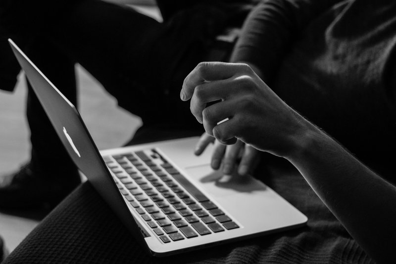 A person typing on their laptop