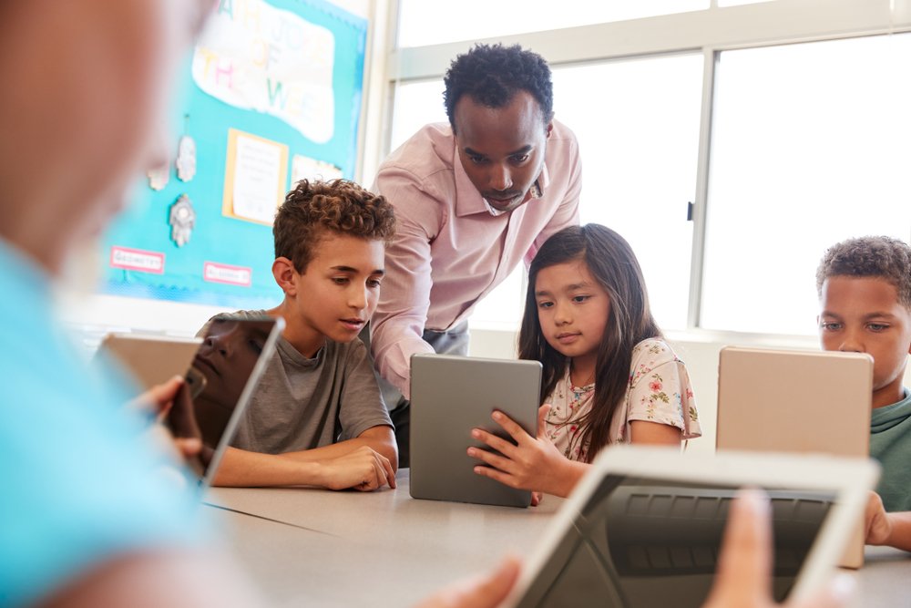 teacher and students using tablets