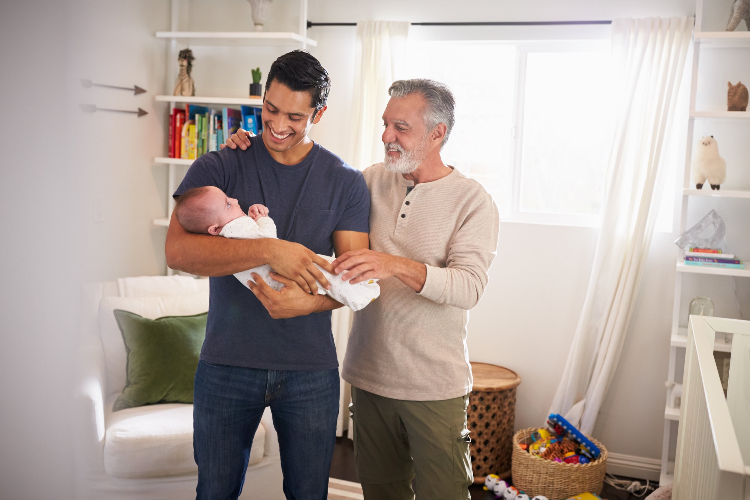 hispanic father and grandfather caring for child