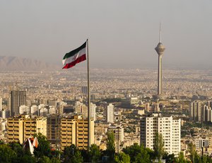 The Iranian flag waves over the city.