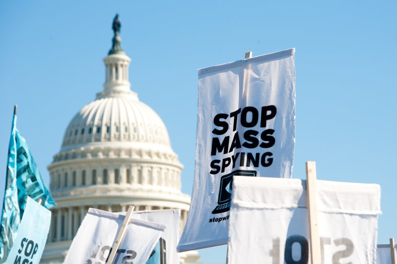 A sign in front of the Capitol which stats "stop mass spying."