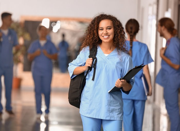 A young nurse standing in a hallway