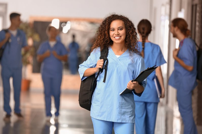 A young nurse standing in a hallway