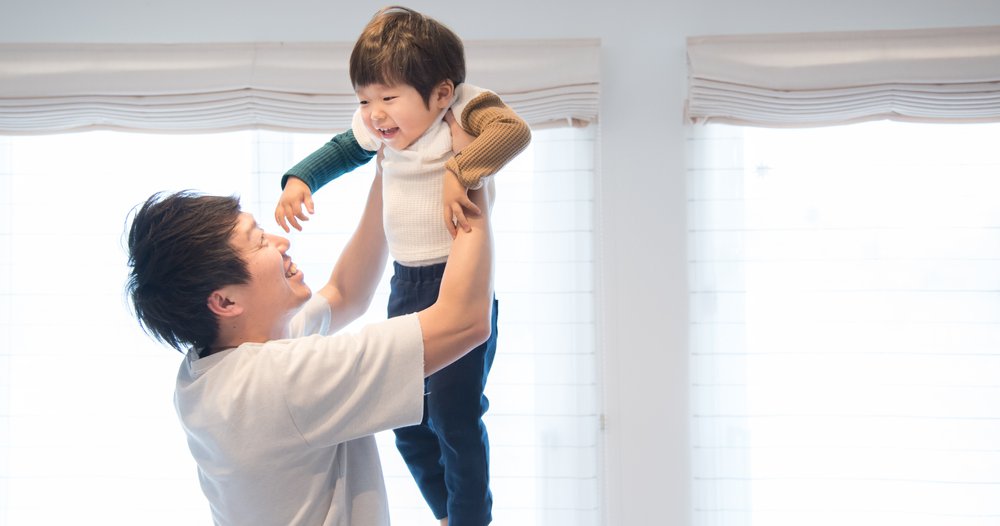 father lifting child