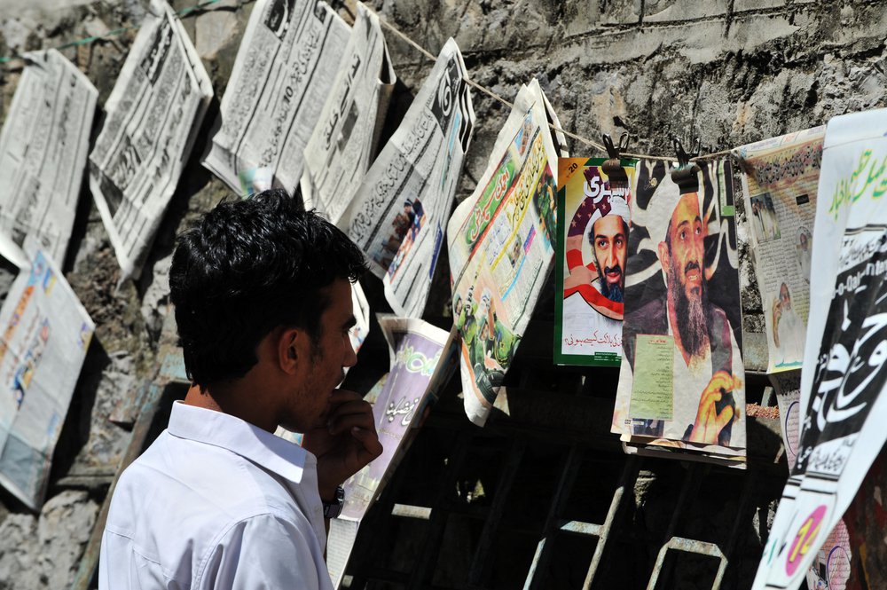 ABBOTTABAD, PAKISTAN - MAY 15: Pakistani man reading newspapers and daily life on May 15, 2011 in Abbottabad, Pakistan