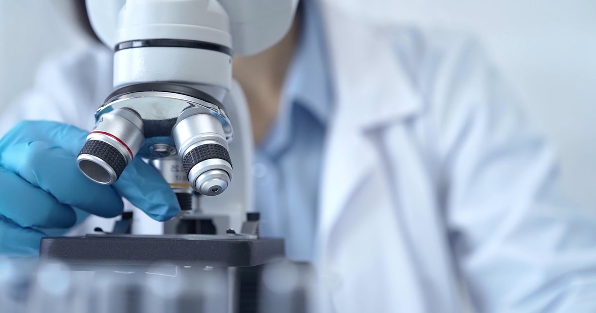 Scientist using microscope in laboratory