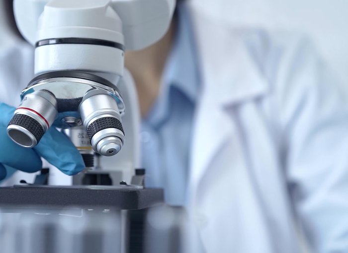 Scientist using microscope in laboratory