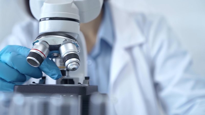 Scientist using microscope in laboratory