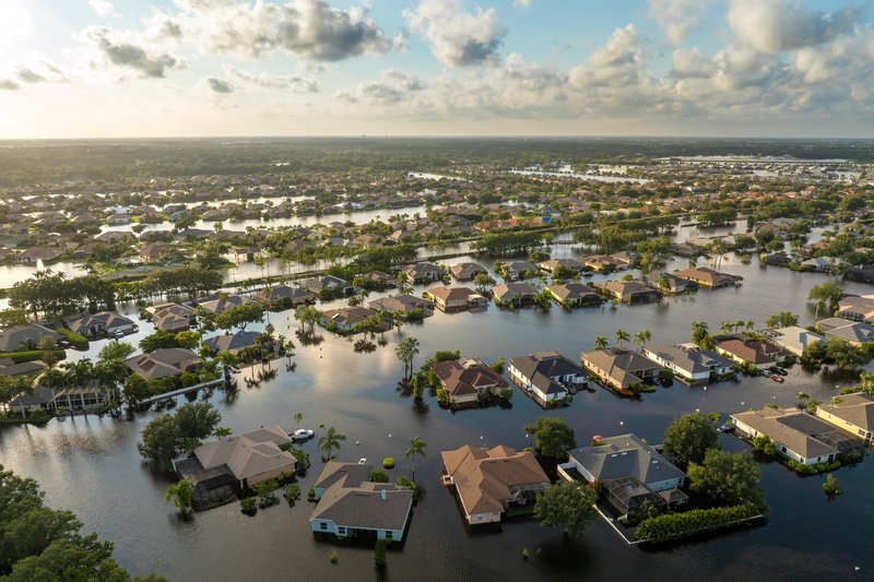 Aerial view of a flooded suburban neighborhood with houses partially submerged.