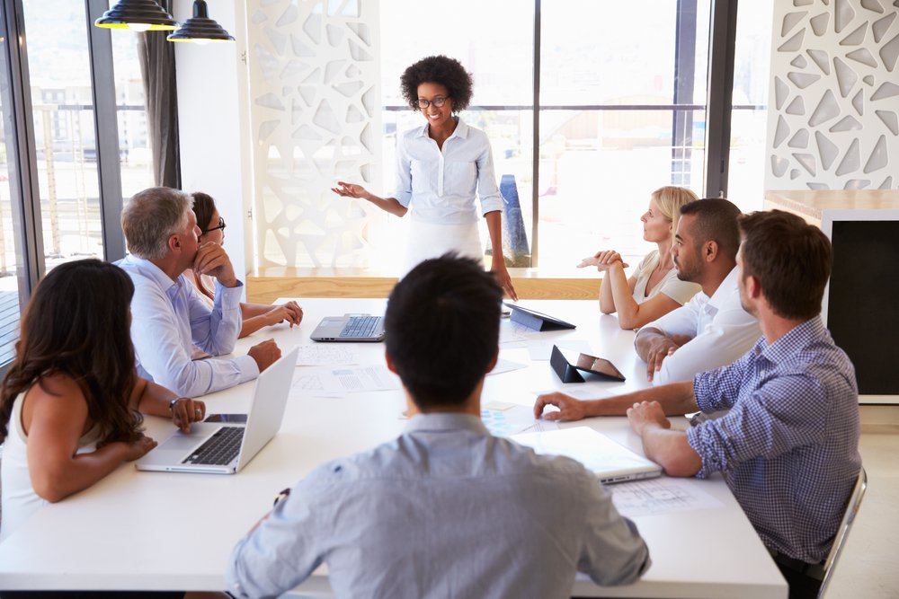 woman giving presentation at meeting conference