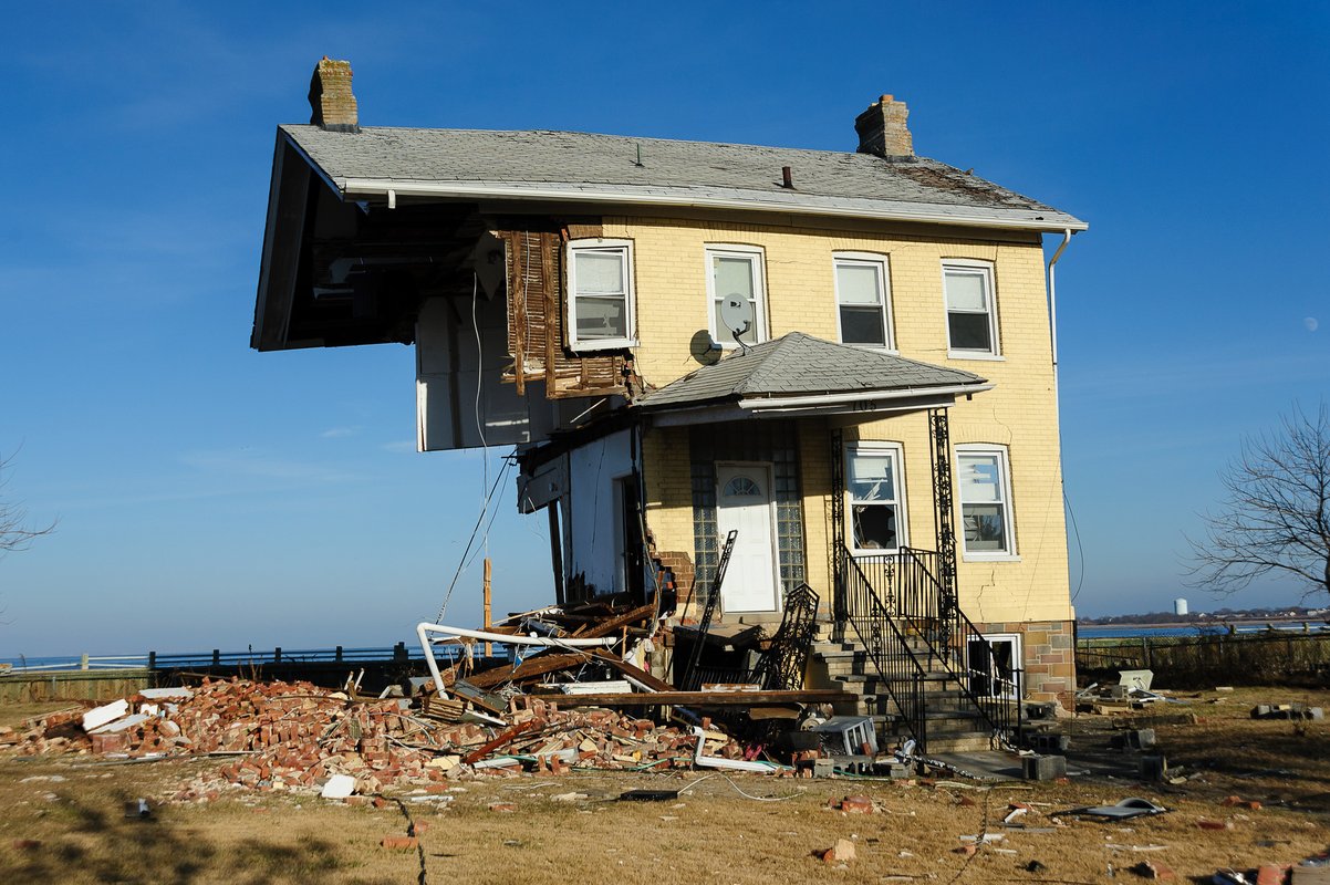 A yellow house that is half-destroyed after Hurricane Sandy