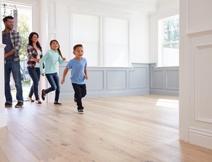 Latino family walking into their new empty home