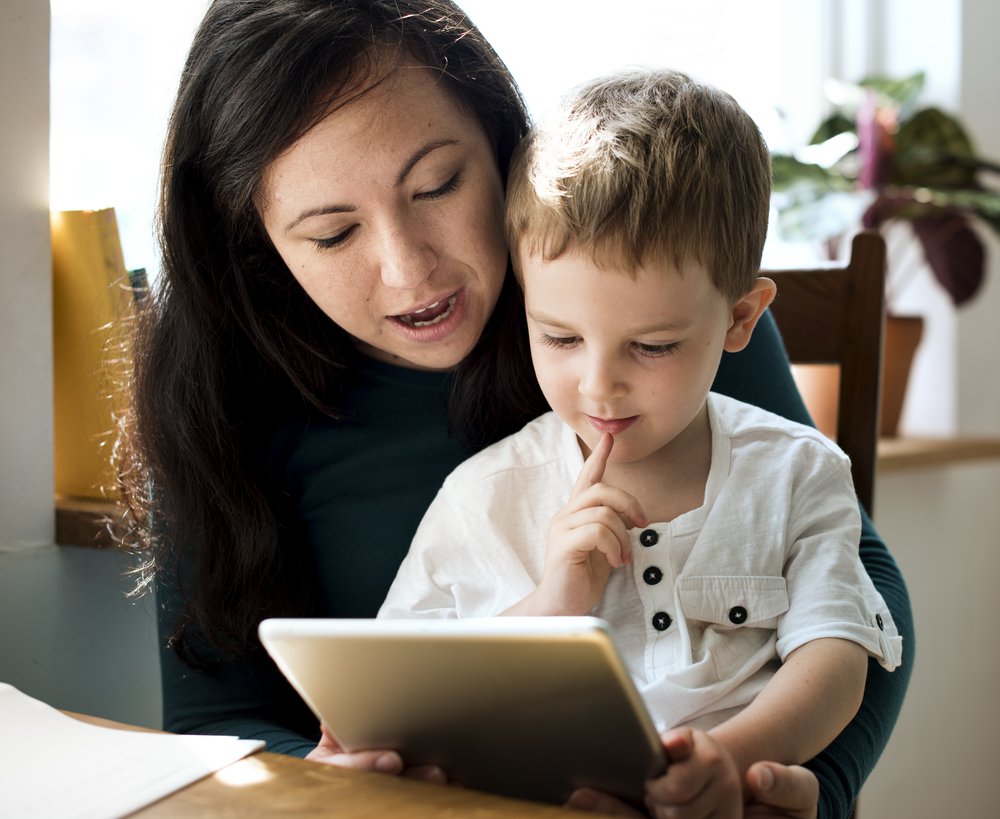 mother and child with iPad