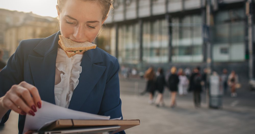a working woman eating on the go