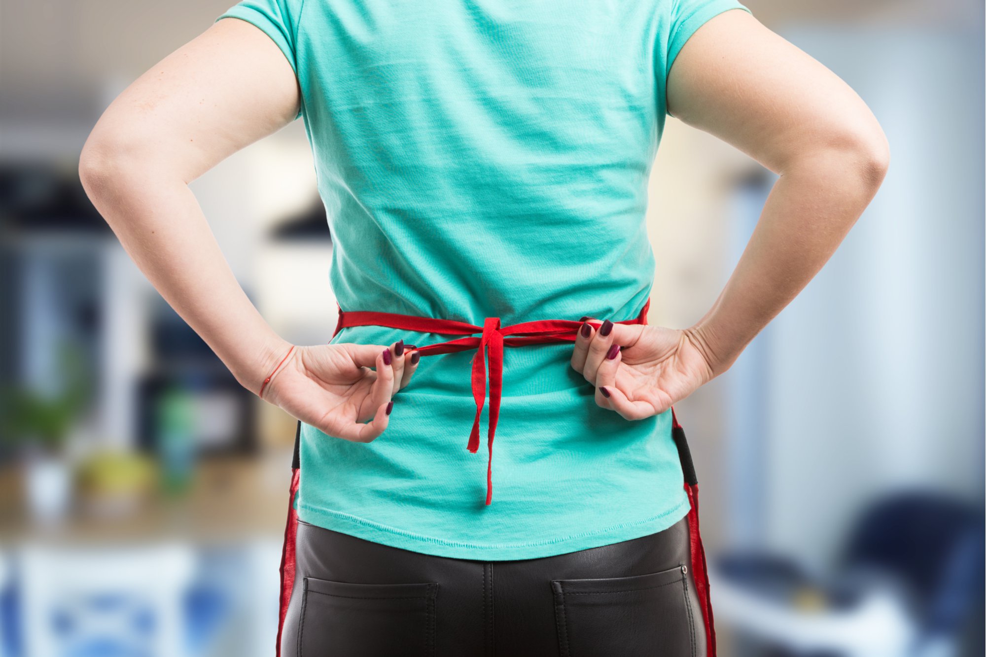woman tying apron from behind