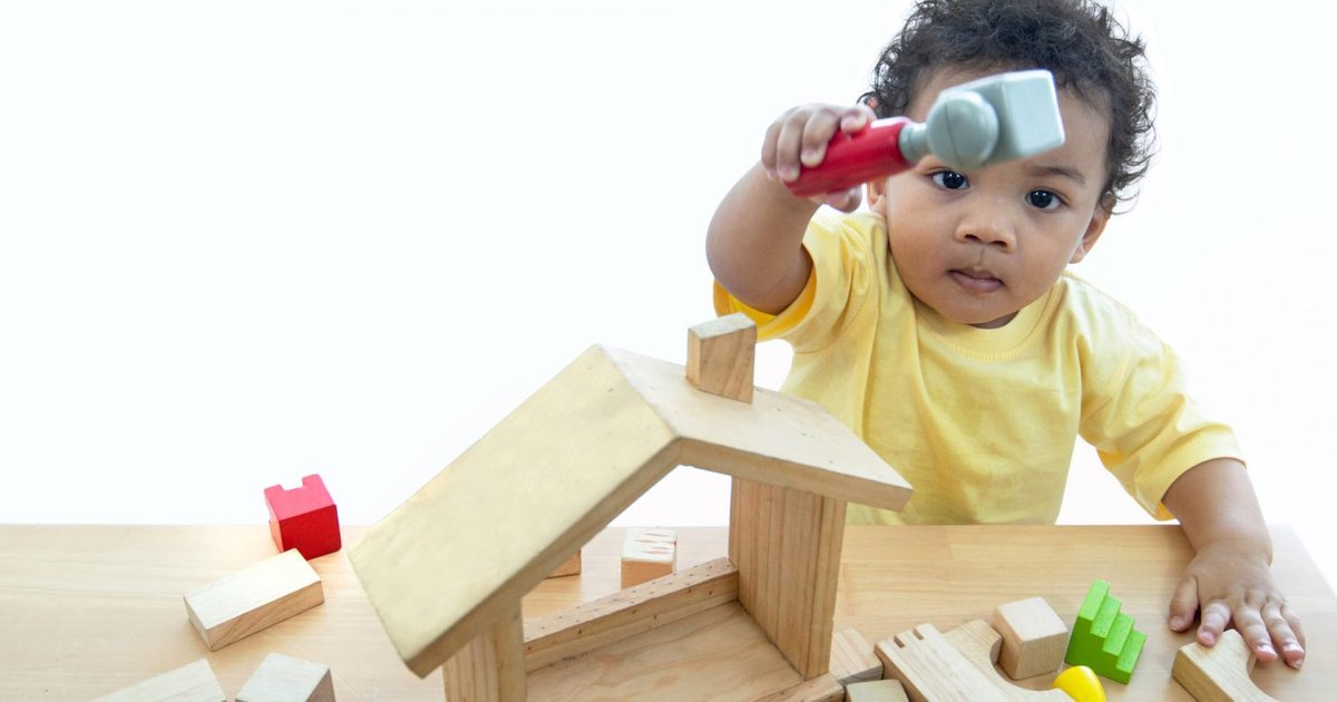 toddler-playing-with-wooden-toy-building-set-1500x750